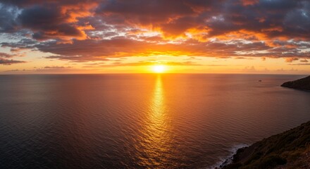 Fototapeta premium Golden Hour Ocean Sunset - Stunning sunset over the ocean, fiery colors reflecting on the water, dramatic cloudscape