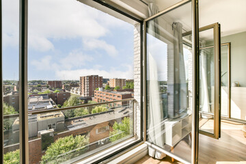 A spacious modern apartment showcases a stunning urban view through large windows, with greenery...