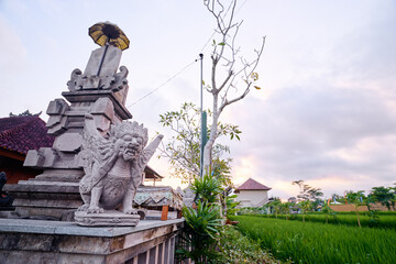 Traditional Balinese Sculpture by the Rice Field at Sunset..