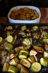 Oven-roasted vegetables: broccoli, zucchini, eggplant, and oyster mushrooms. Healthy, colorful dinner, perfect for family meals. Nutritious plant-based food, vegetarian cuisine