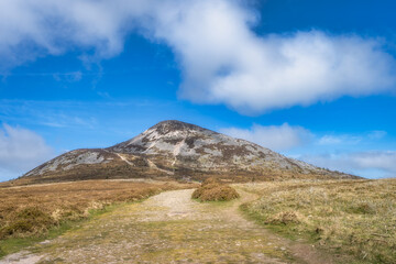 A beautiful path leads to a majestic Sugarloaf mountain peak surrounded by lush greenery and a...