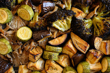 Oven-roasted vegetables: broccoli, zucchini, eggplant, and oyster mushrooms. Healthy, colorful dinner, perfect for family meals. Nutritious plant-based food, vegetarian cuisine