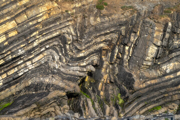 This stunning image showcases unique wavy patterns in rock strata, highlighting the fascinating...