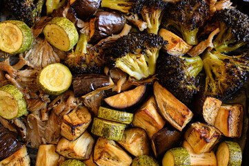Oven-roasted vegetables: broccoli, zucchini, eggplant, and oyster mushrooms. Healthy, colorful dinner, perfect for family meals. Nutritious plant-based food, vegetarian cuisine