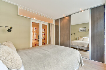 Stylish bedroom featuring contemporary decor with soft textures, a cozy bed, and natural light highlighting the space's elegance.