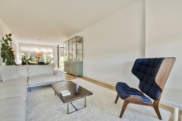 A stylish and contemporary living room featuring a comfortable sofa, elegant decor, and ample natural light, creating a cozy yet sophisticated atmosphere.