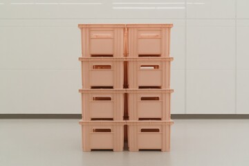 Stacked storage boxes in soft peach tone create an organized, mi