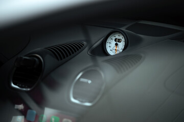 Close-up interior view of a sports car's dashboard