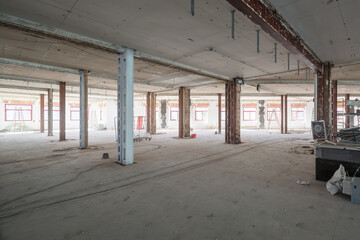Industrial space under renovation with exposed beams and materials