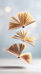 Books floating in mid-air against a soft background