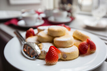 Strawberry pastry served with coffee on a white plate