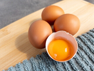 chicken eggs on a wooden surface