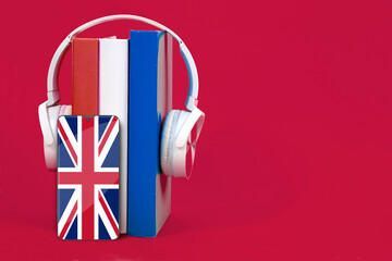 Learning English, headphones and textbooks. Listening to English literature books, audiobook. UK...