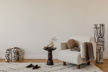 Elegant beige sofa, abstract pillows and organic decor elements in a calm, modern interior.
