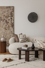 Soft-toned interior with abstract art, fluted side table and cozy sofa with ceramic decor..