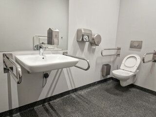 Public disabled toilet. Handrails for people with disabilities