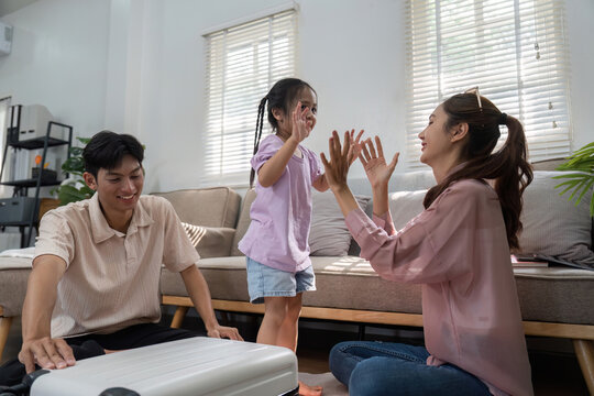 Family Playtime and Bonding. A joyful family engages in a fun clapping game, enhancing their connection and creating lasting memories.