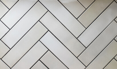 Ceramic tile, herringbone tile, Beige tiled wall texture background