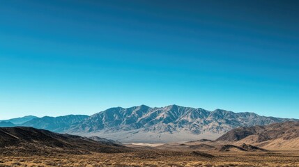 Scenic view of rugged mountains against a clear blue sky