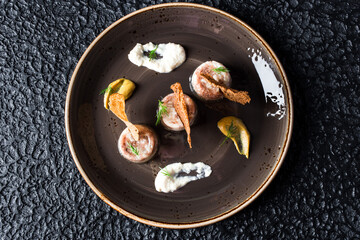 Jellied Seafood Appetizers in black plate on black background.
