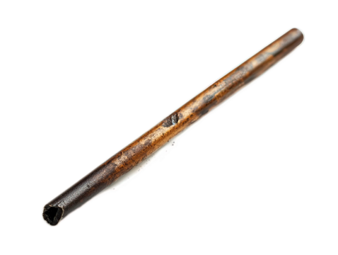 Tactical fire starter rod with striker tool, shower of sparks visible, ferrocerium material showing wear marks from use, white background