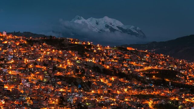 Day to night timelapse of La Paz cityscape and Illimani mountain in Bolivia, South America.