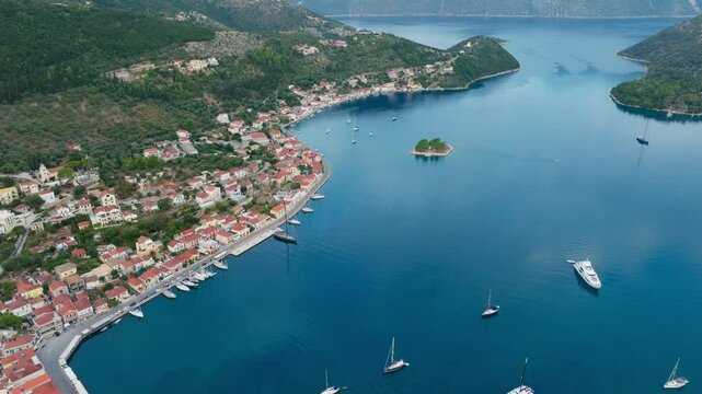 Aerial view of sailboats moored in the picturesque port of Vathy village during overcast day, Ithaca island, Greece