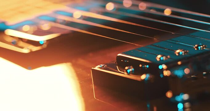 Close-Up of an Electric Guitar. Details of strings, frets, and the body shine under moody lighting. Music, creativity, and rock culture.