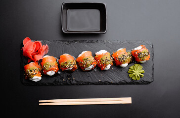 Delicious Sushi Rolls with Wasabi and Pickled Ginger on Slate Platter