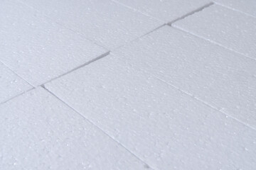 Fototapeta premium Foam board texture background. Close-up cut foam sheets texture. Plastic, sponge, soft packaging material, white, blank, rough, abstract for texture, cover. Texture background of white foam board.