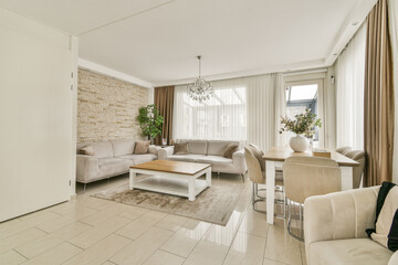 A chic and spacious modern living room featuring elegant furniture, large windows, and stylish decor, creating a welcoming and comfortable atmosphere.