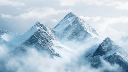 Obraz premium Snowy mountain peaks with low clouds above