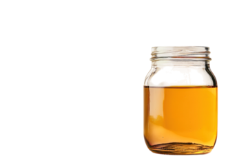 Golden honey in a glass jar on a beige background simple product shot with soft light