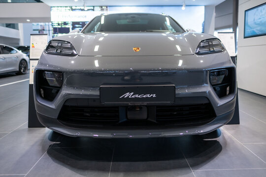 electric Porsche Macan displayed in showroom, eco-friendly dynamic styling and high-performance characteristics, Frankfurt - January 25, 2025