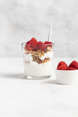 yogurt with granola and raspberries