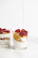 yogurt with granola and raspberries