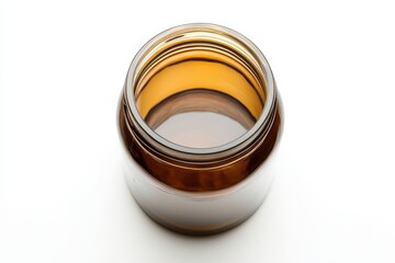 Amber glass jar with golden liquid top view minimalist product shot clean background