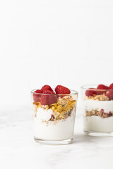 yogurt with granola and raspberries