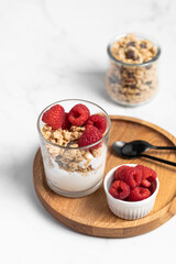 yogurt with granola and raspberries, breakfast