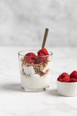 yogurt with granola and raspberries, breakfast