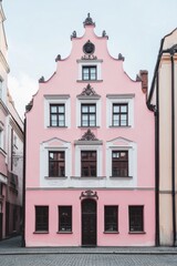 Fototapeta premium Colorful historic building in a quaint street showcases beautiful architecture during the early hours of the day in a charming European town