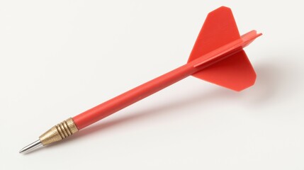 red dart with metallic tip and plastic fins lies on white background