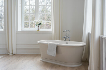 Modern elegant minimalist bathroom interior with curtains and window and freestanding bathtub. Home interior, house design with relax atmosphere