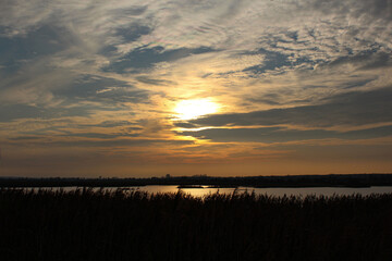 Evening sky in yellow-golden tones over the lake