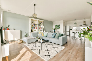 A stylish modern living room featuring a cozy sofa, vibrant plants, and a well-organized bookshelf, creating an inviting ambiance for relaxation.