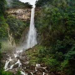 aerial view of a waterfall in a misty forest, in south east asian mountains	