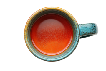 Vibrant red liquid in a rustic teal mug overhead shot earthy tones speckled glaze