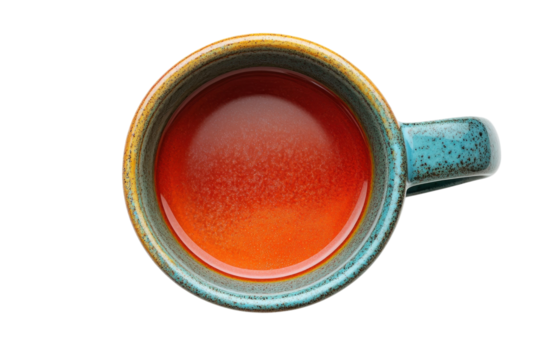 Vibrant red liquid in a rustic teal mug overhead shot earthy tones speckled glaze