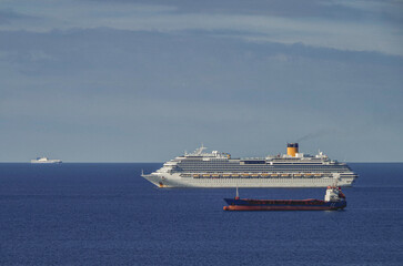 Mega family cruiseship cruise ship liner Favolosa and bunker ship anchored offshore of...