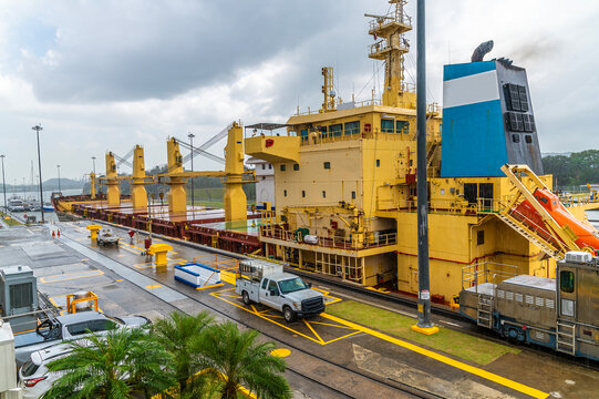 A view of a large vessel in the penultimate seaward lock at Miraflores for the Panama Canal beside Panama City in the morning in springtime